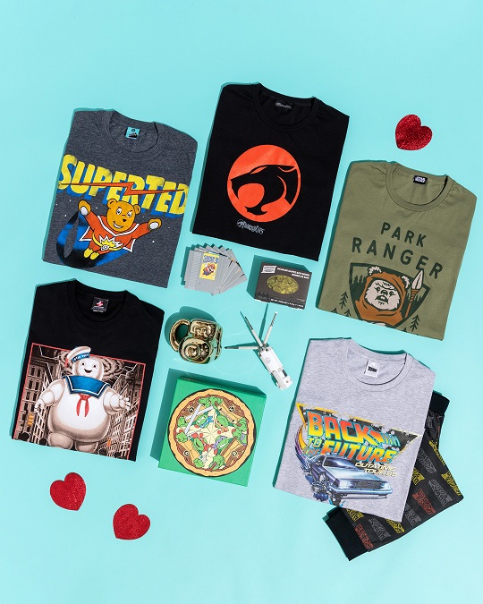 Flat lay short on a blue background of retro tshirts, gifts and accessories with red hearts