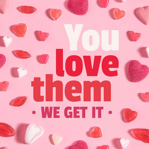 Red Love heart sweets on a pink back ground with the text you love them, we get it.